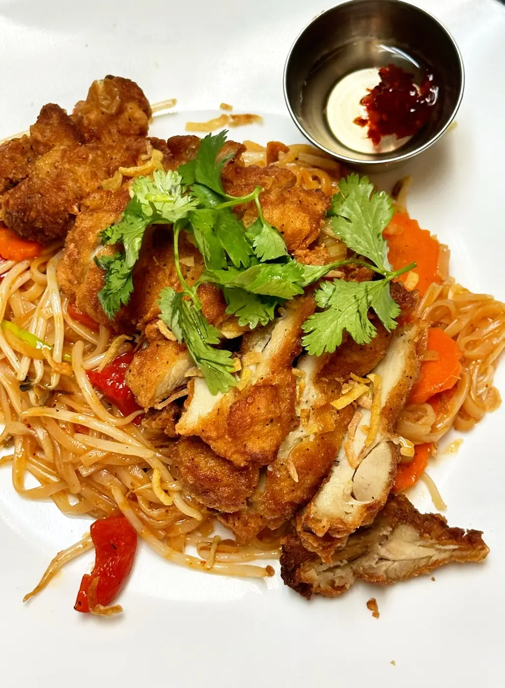 Thai noodles topped with crispy chicken